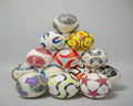 Pile of multicolored patterned balls on a gray background